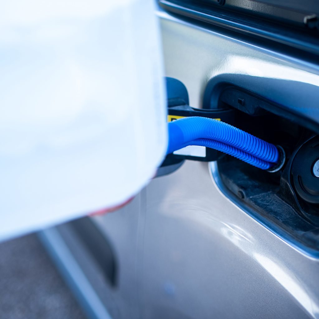 pouring-adblue-car-adding-diesel-exhaust-fluid-Adblue-production-plant-technodorf-facility-system-vda